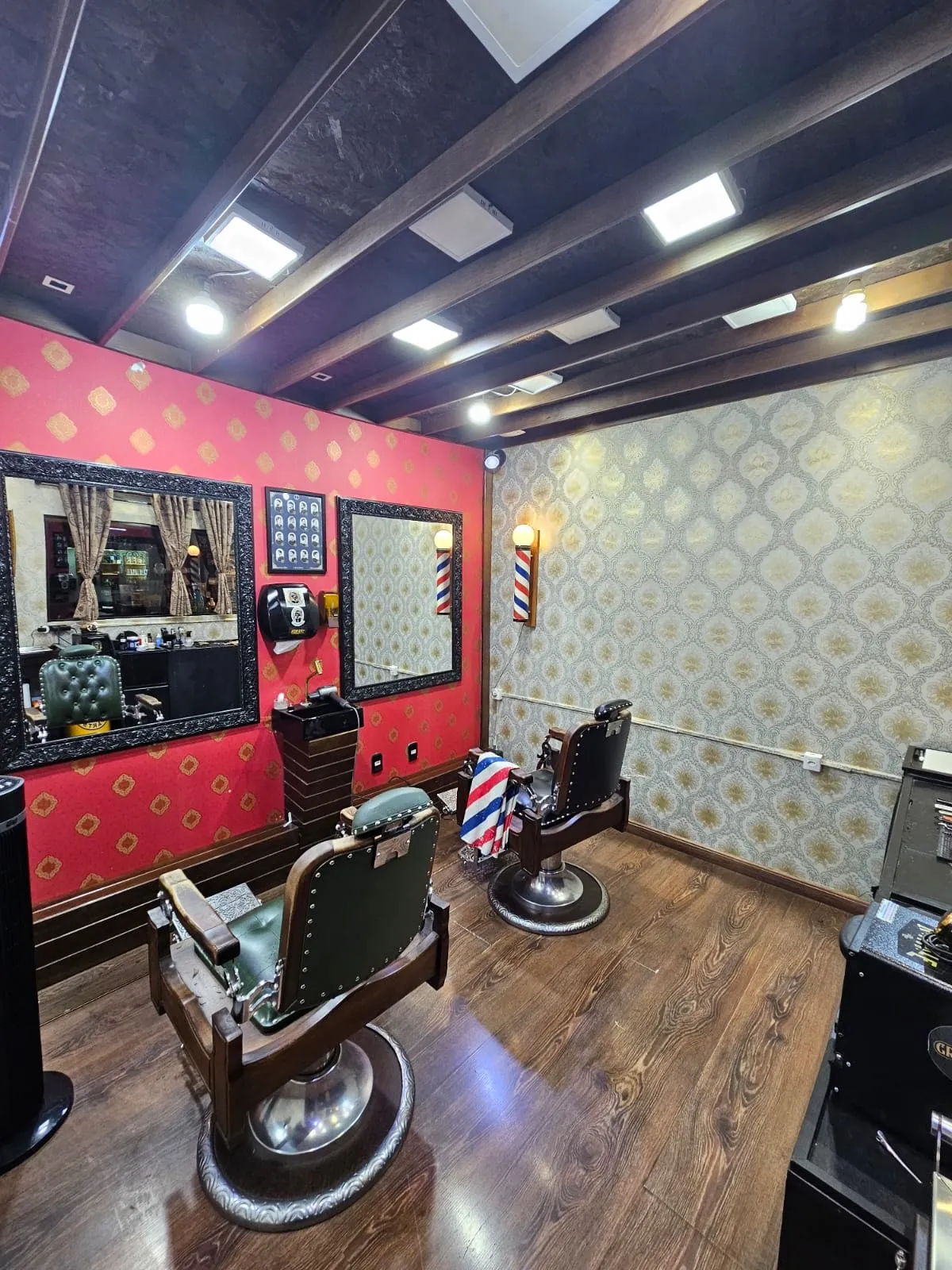 Sala reservada com parede vermelha e cadeira de barbeiro clássica